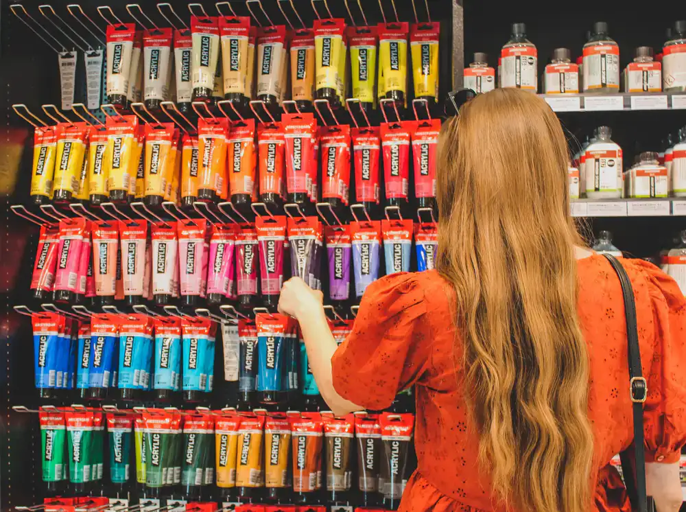 Rows of vibrant acrylic paints on a specialized hobby rack