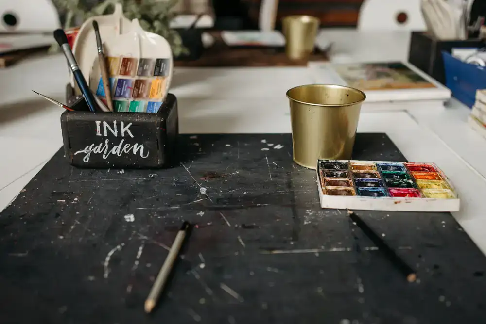 High quality painting brushes and miniature paints on a desk