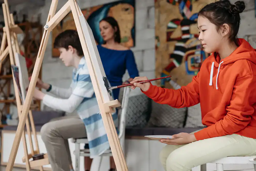 Instructor guiding a student in miniature painting